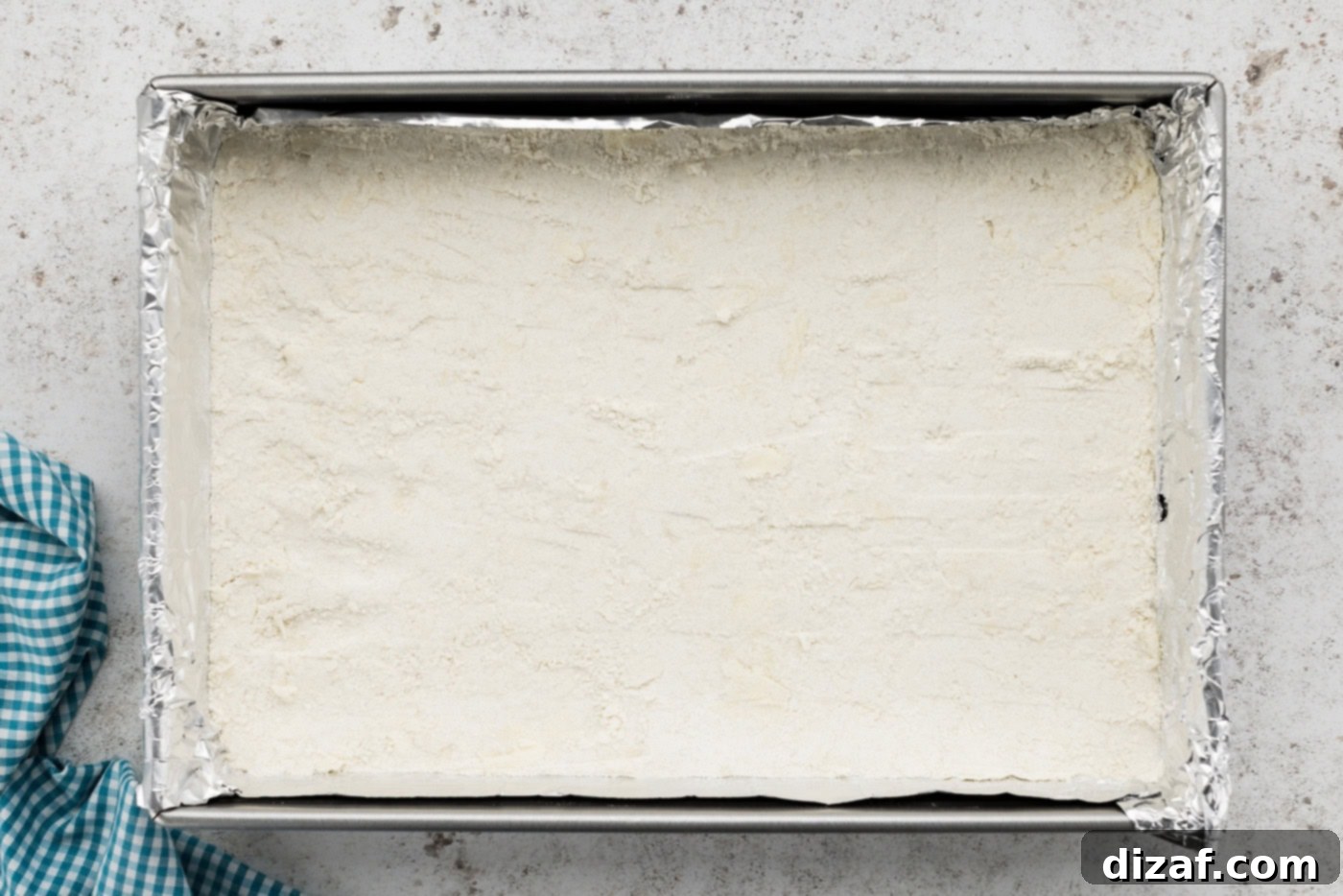 shortbread crust pressed evenly on the bottom of a baking dish, lightly baked