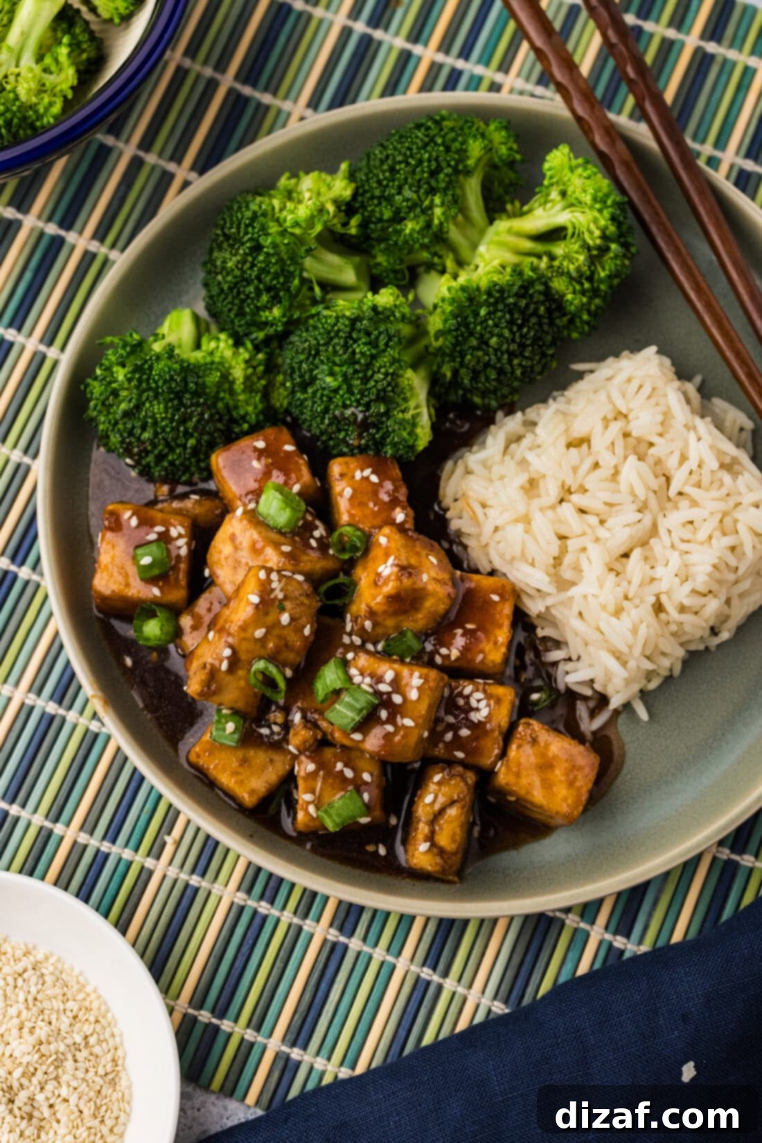 Savory Glazed Teriyaki Tofu 16 Plate of Crispy Teriyaki Tofu with steamed broccoli and fluffy white rice, ready to be enjoyed.