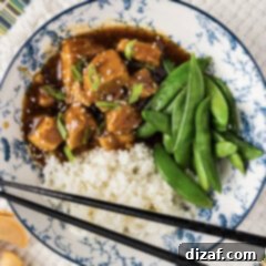 Honey Garlic Chicken in the Instant Pot 12 Close up photo of a bowl of Instant Pot Honey Garlic Chicken with rice and sugar snap peas