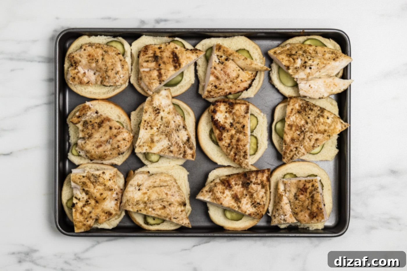 cooked chicken on top of sliders buns