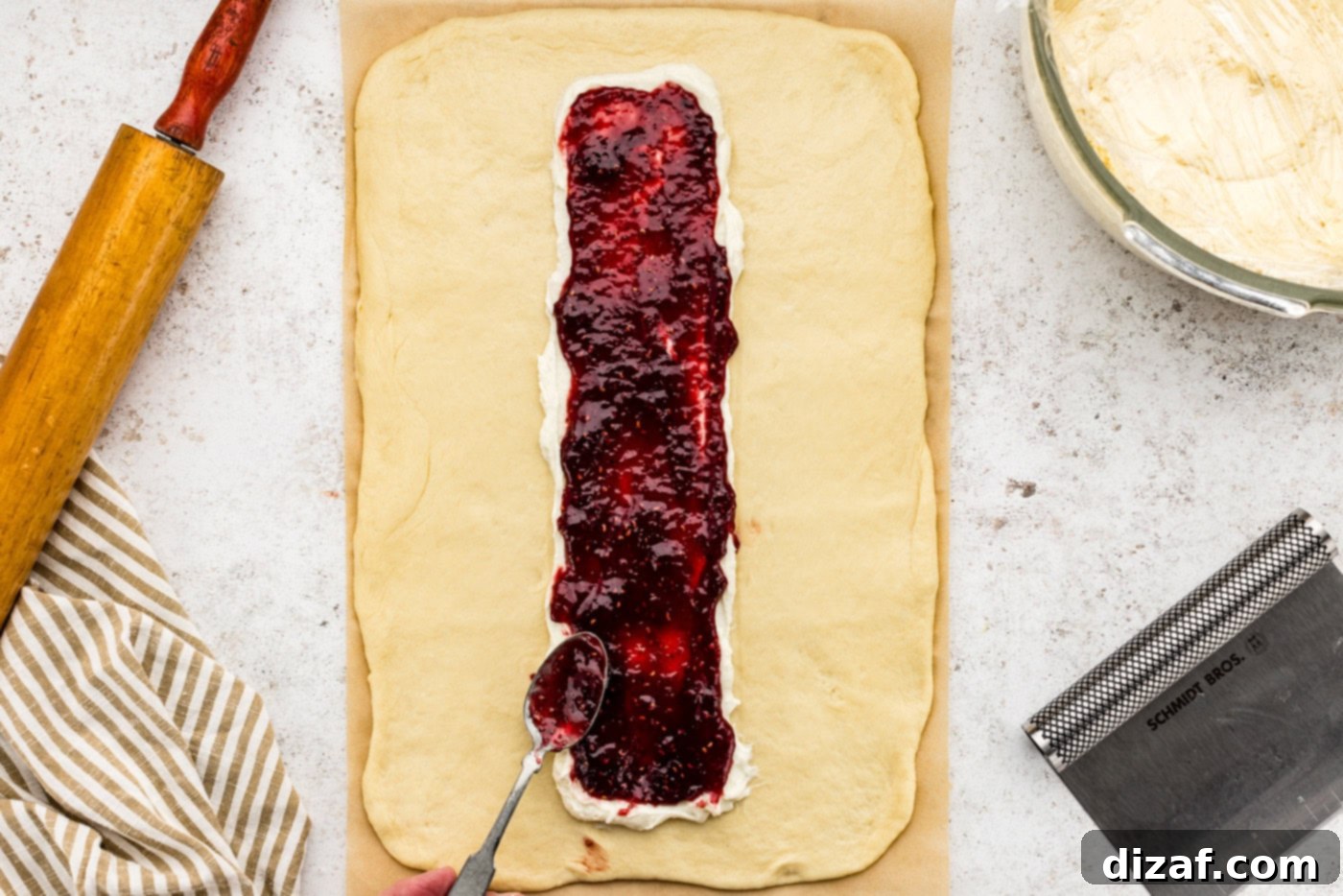 adding preserves on top of cream cheese filling
