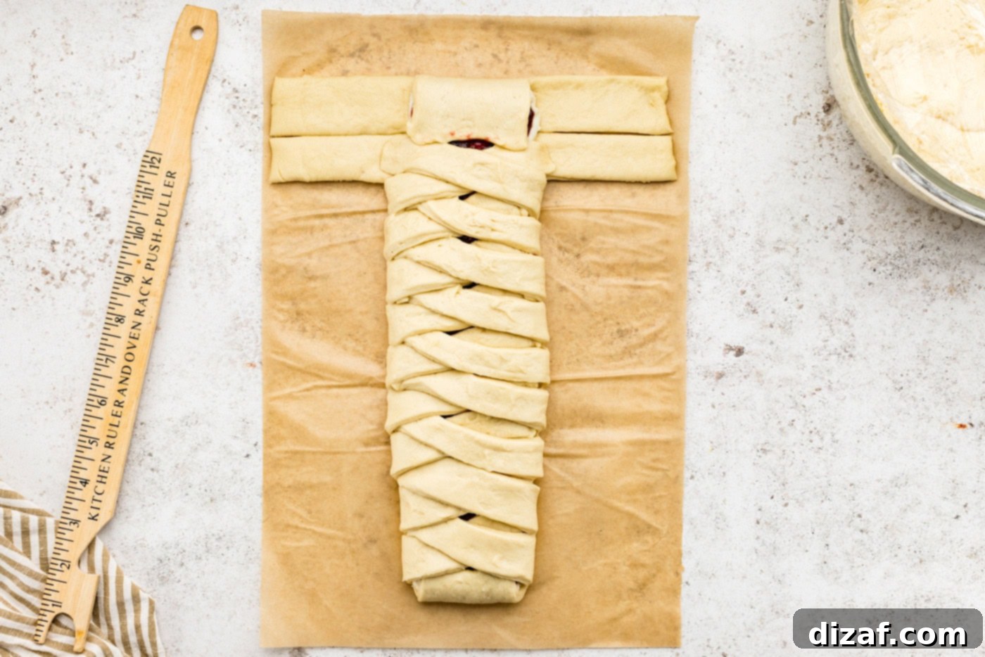 folding the end tab of the sectioned dough over the filling