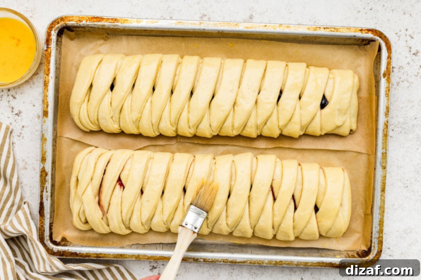 brushing danish dough with egg wash
