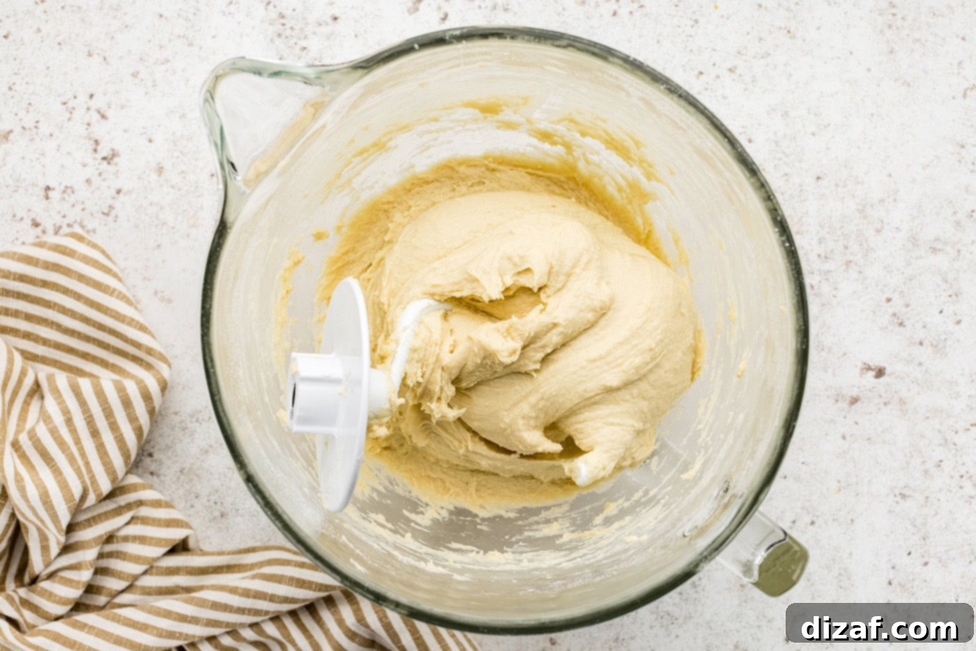 breakfast danish dough in a stand mixer bowl with hook attachment