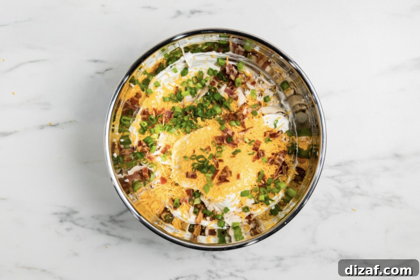 Chicken bacon ranch dip ingredients in a mixing bowl