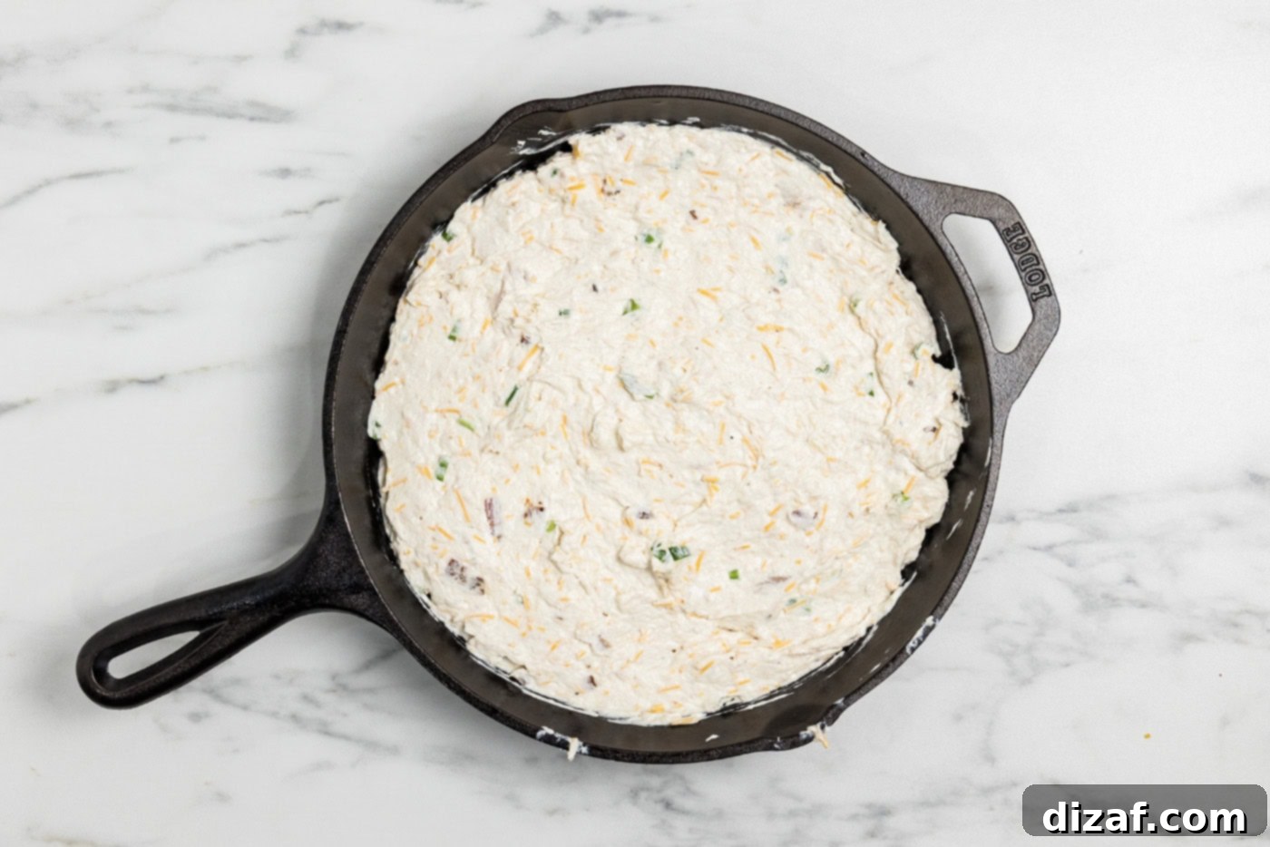 Chicken bacon ranch dip mixture in a cast iron skillet