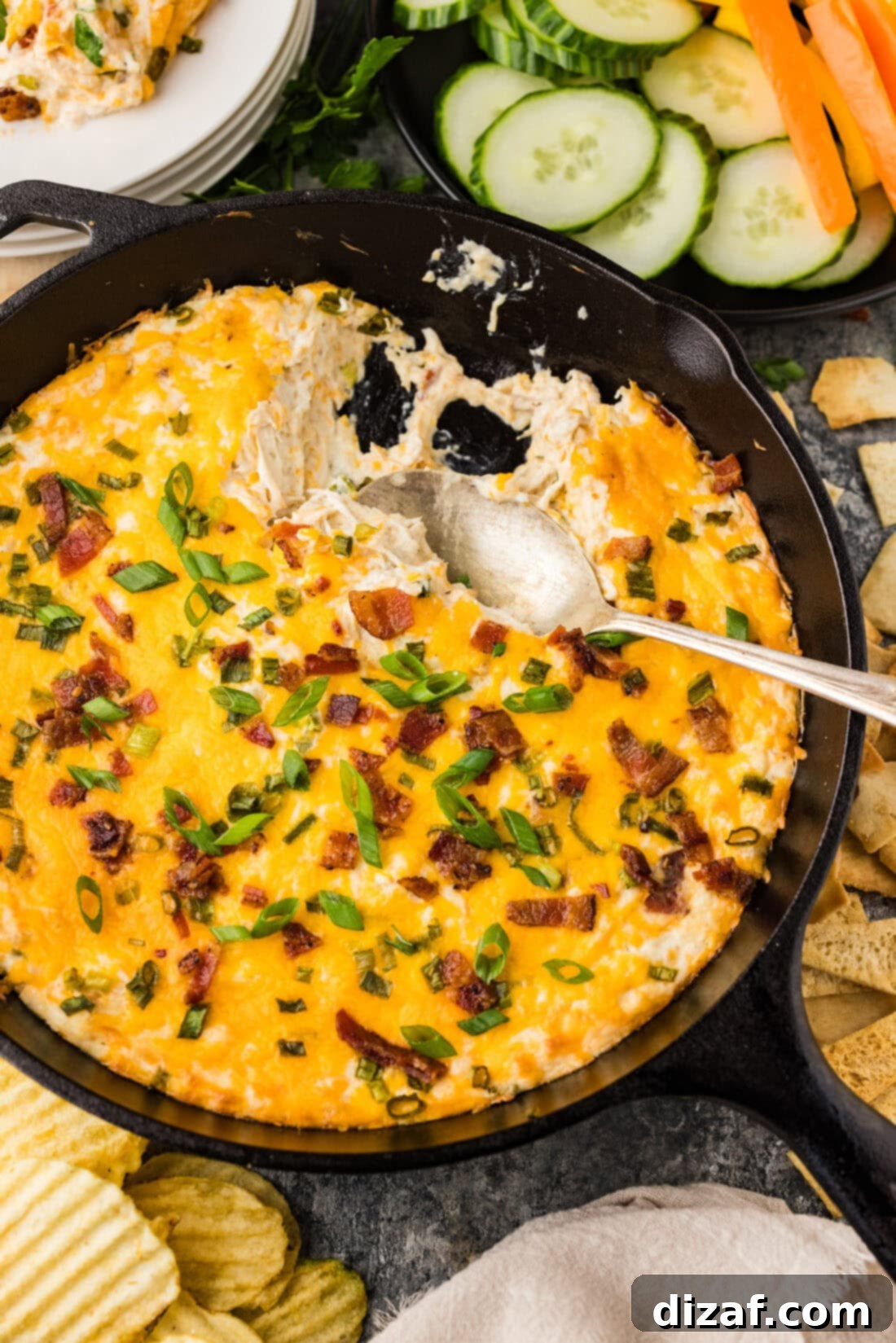 Spoon in a skillet of Chicken Bacon Ranch Dip
