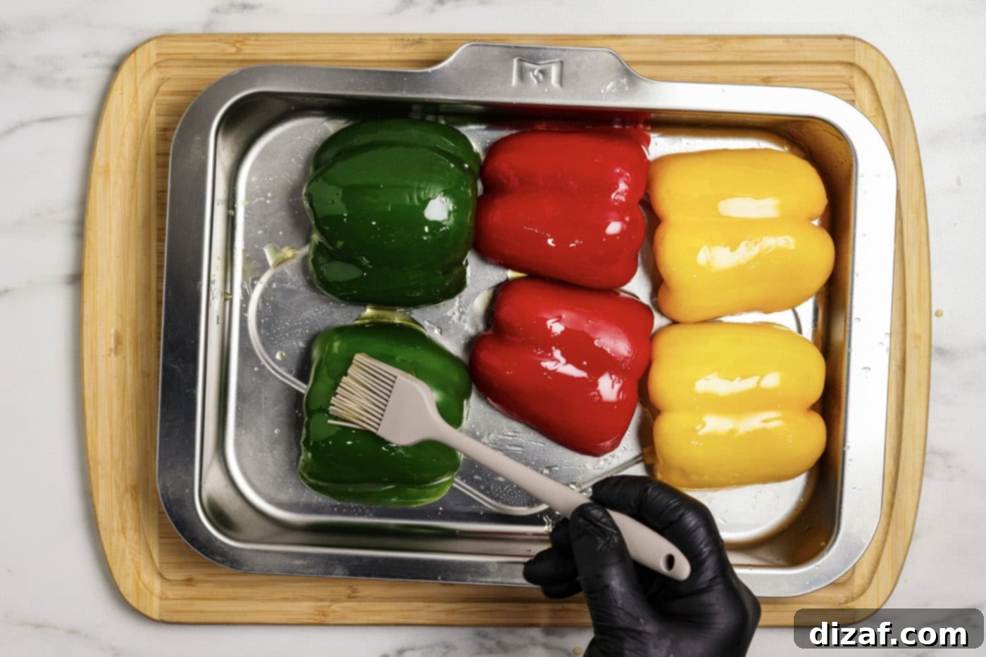 Brushing bell peppers with olive oil