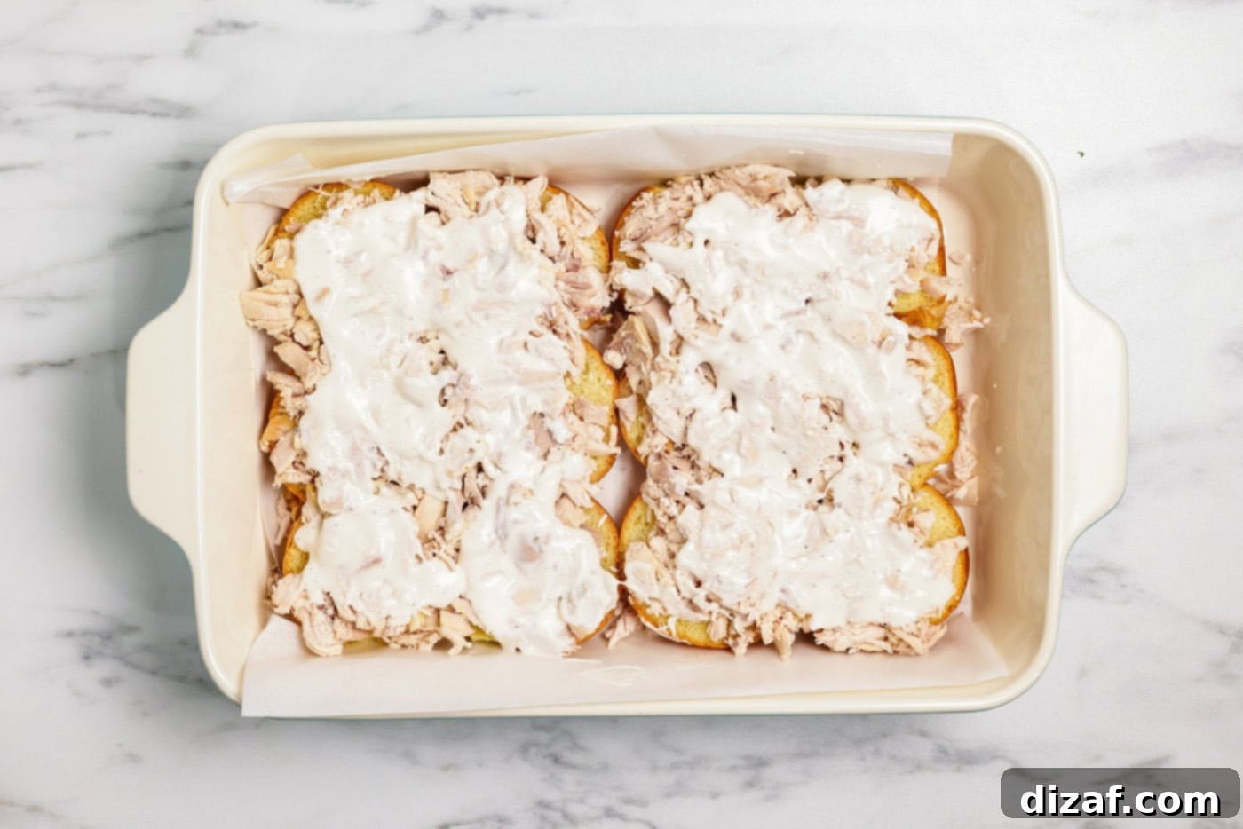 Ranch dressing on slider buns in baking dish