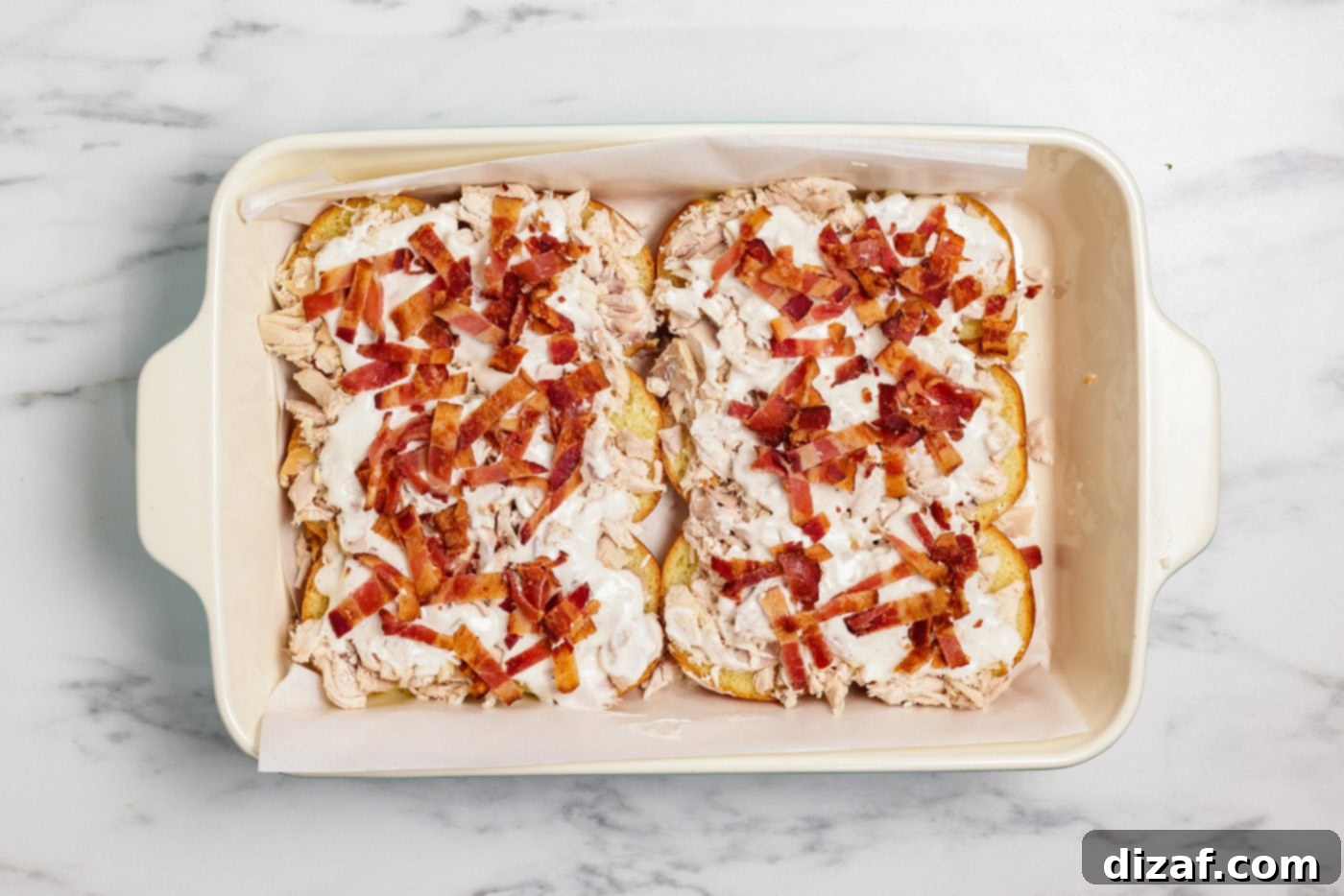 Chopped bacon on ranch and chicken over slider buns