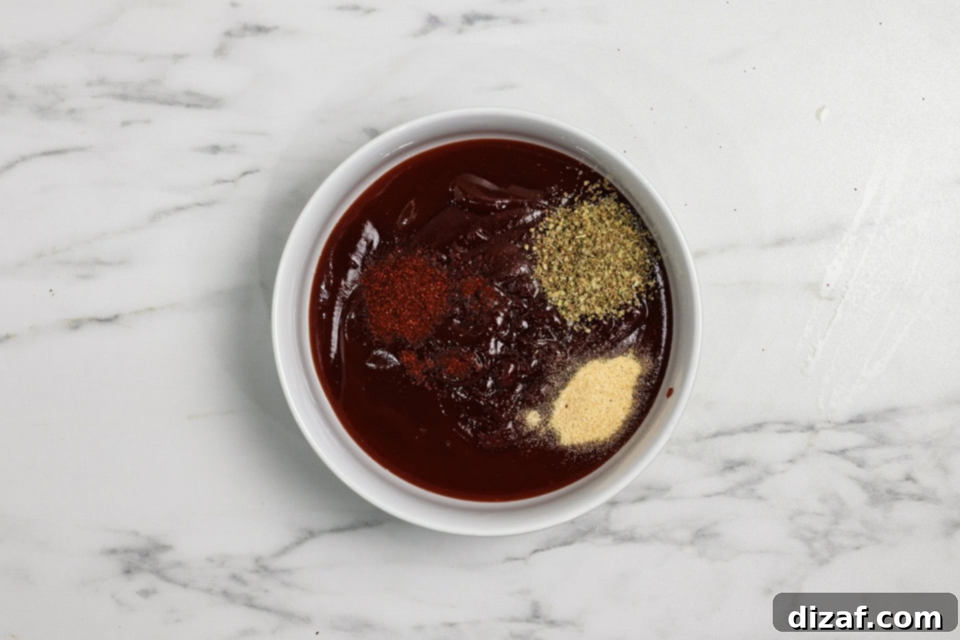 spices and seasonings in a bowl with barbecue sauce