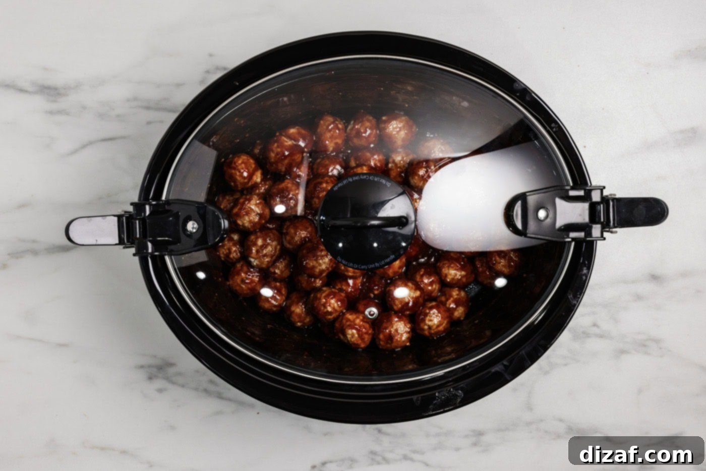 Barbecue meatballs in a crockpot covered with a lid