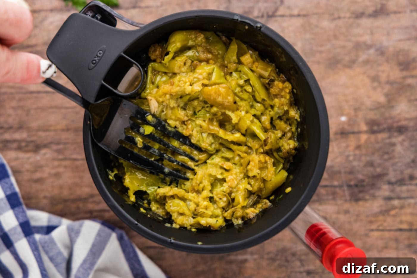 smashed pepperoncinis in the lid of a fat separator
