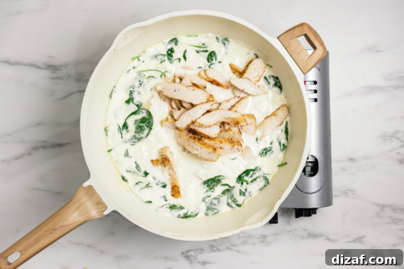 Garlic Chicken Pasta Sizzling Garlic Chicken Pasta Perfection 7 spinach and sliced chicken added to garlic cream sauce in a skillet